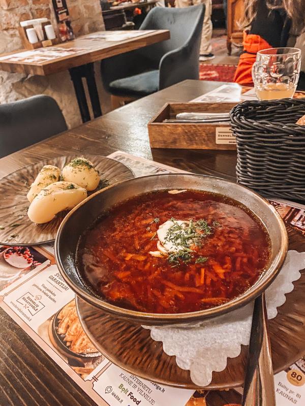 a plate of beet soup with bread