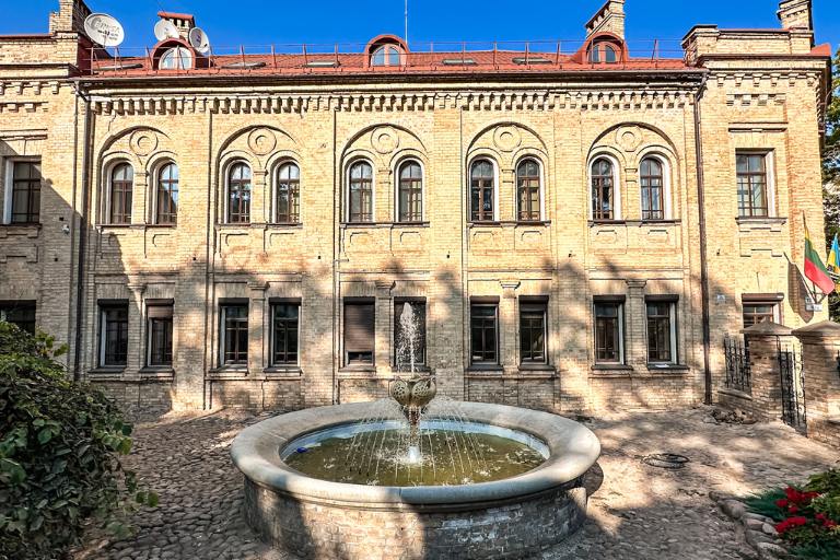 historic building in Vilnius with a fountain in the courtyard