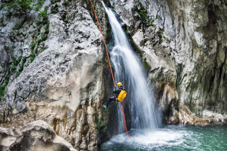 person canyoneering in a gorge