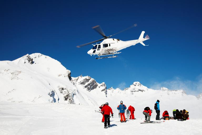 group of snowboards by a helicopter