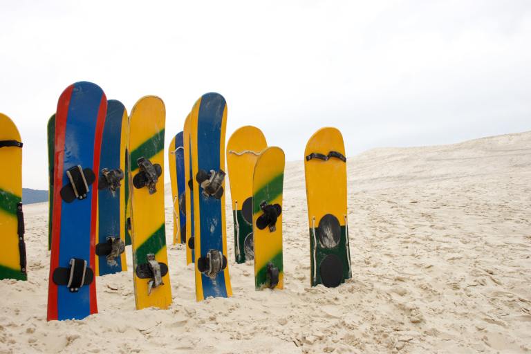 a group of sandboards in the sand