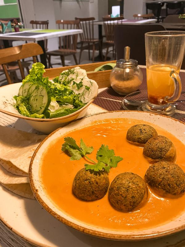 plate of vegan balls in orange sauce