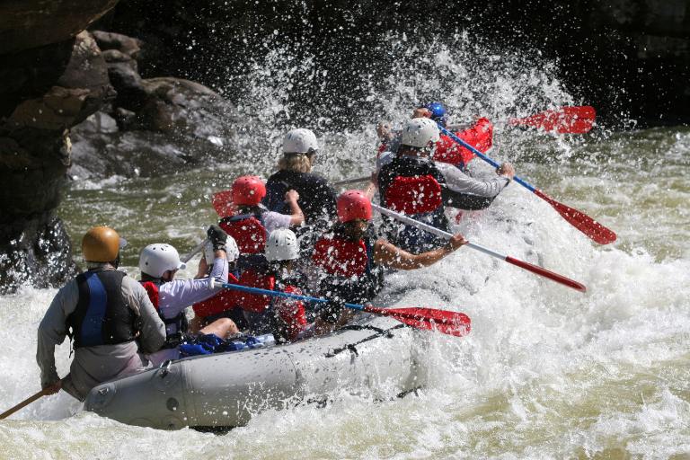 a group of people white water rafting