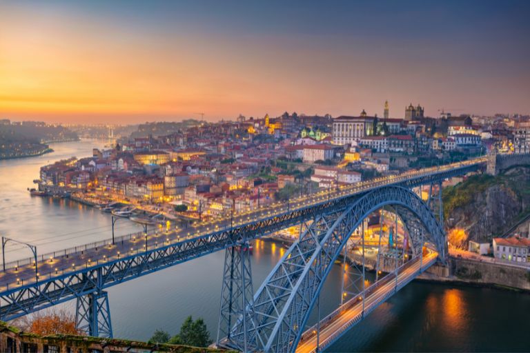 a bridge over a river with a city in the background